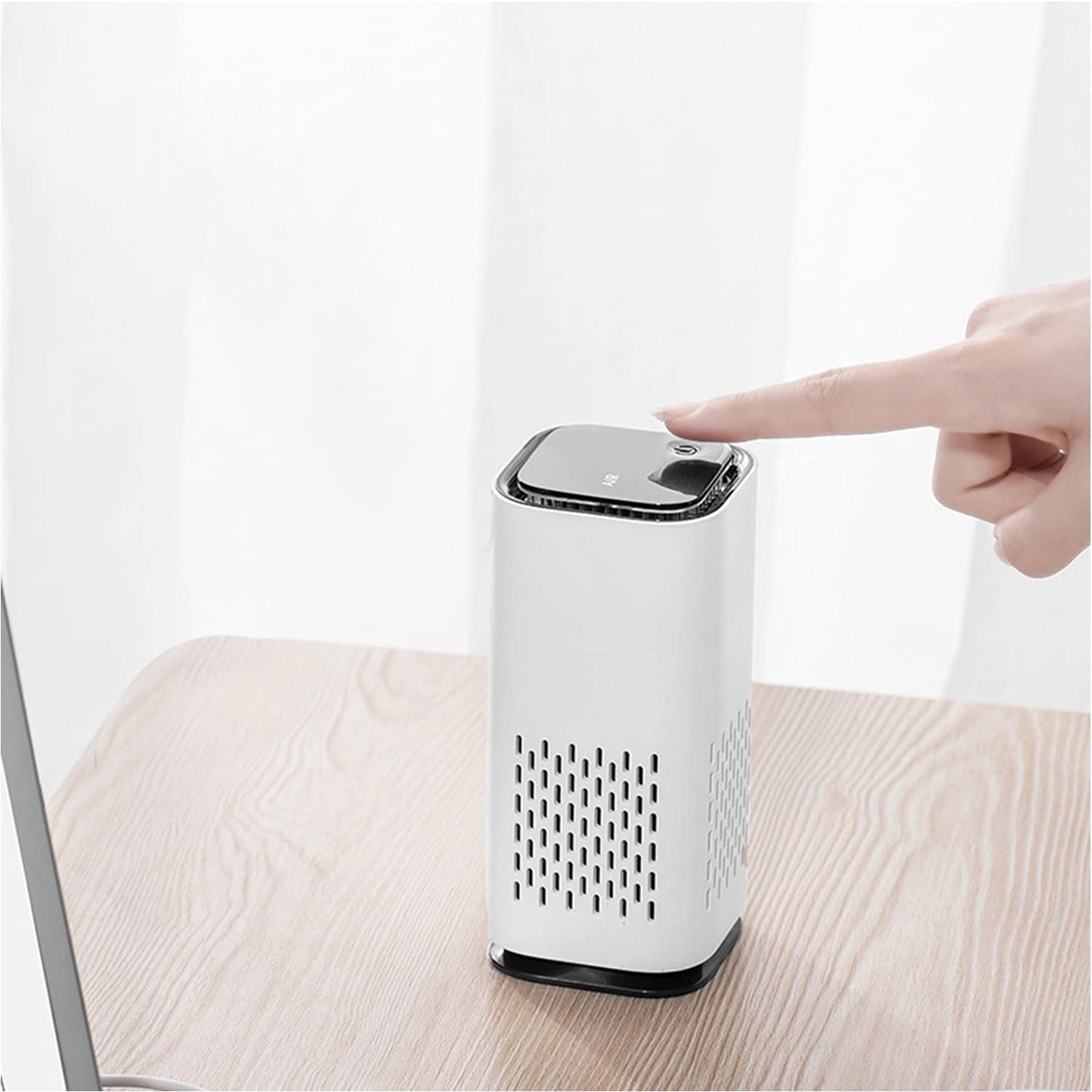 AirPure™ Mini Portable Pet Air Purifier on a table, showcasing its compact design and easy-to-use button.