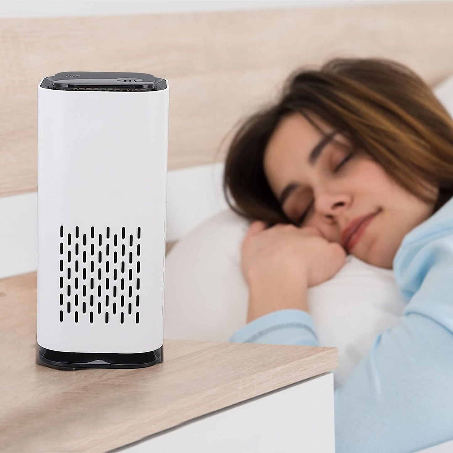 AirPure™ Mini Portable Pet Air Purifier placed beside a sleeping woman on a bedside table, ensuring cleaner air.