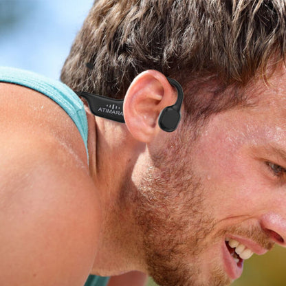 Man using wireless bone conduction headphones during outdoor exercise, showcasing open ear listening experience.